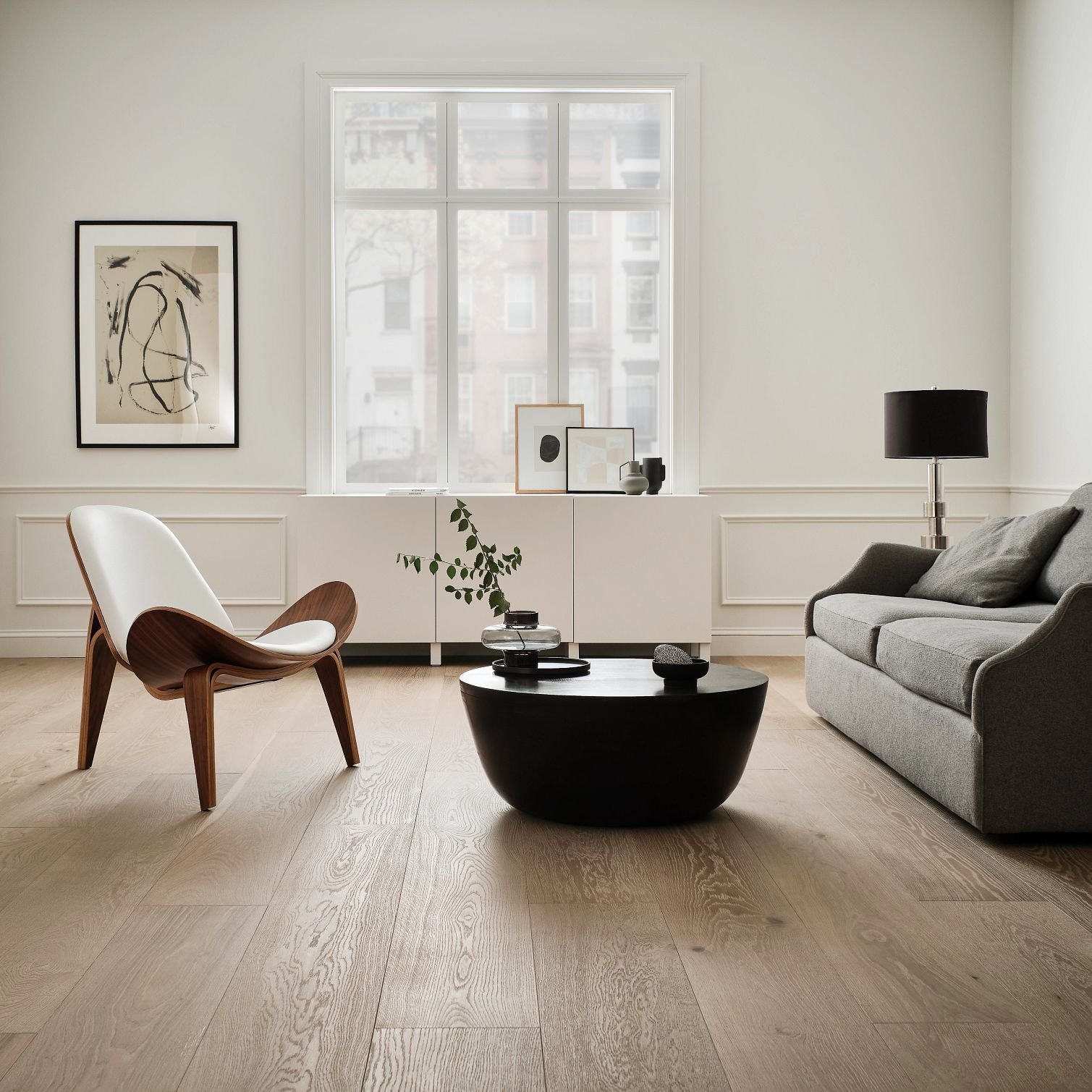 living room flooring with beige chair and gray sofa